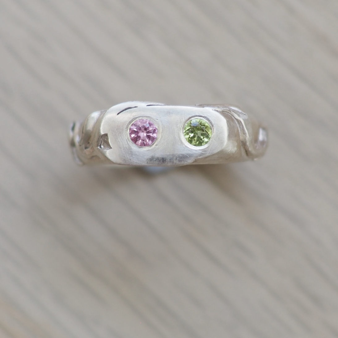 Small decorative item with natural topaz and peridot gemstones on a textured  vine leaf surface